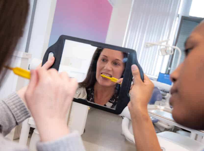 Dental Nurse showcasing Oral Health brushing